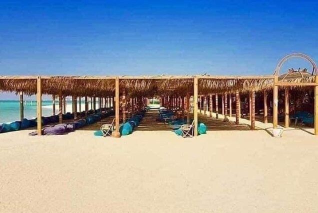 Wooden umbrellas and shaded relaxation areas on Orange Bay Hurghada beach