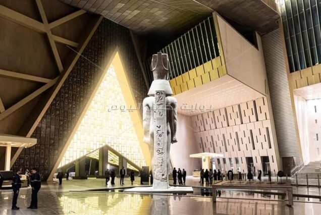 Inside the Grand Egyptian Museum atrium featuring the colossal Ramses II statue