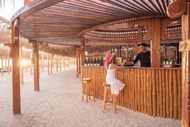 Young woman enjoying a refreshing drink on the boat during Orange Bay Hurghada trip