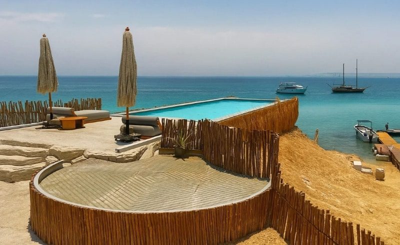 Ozaria Island Hurghada Trip panoramic beach view with swimming pool Ozaria Island Hurghada Trip Prices & VIP Boat Guide 2026