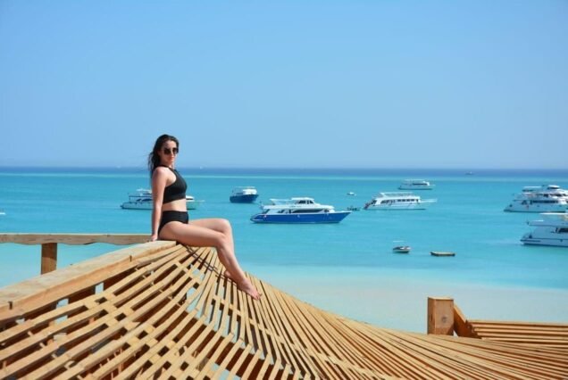 A girl relaxing on the white sands of Orange Bay island in Hurghada